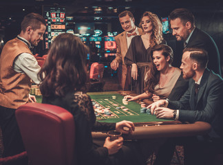 Wall Mural - Upper class friends gambling in a casino