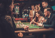 © Nejron Photo - Upper class friends gambling in a casino