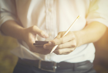 Wall Mural - businessman working with modern devices, digital tablet computer and mobile smart phone,selective focus,vintage color