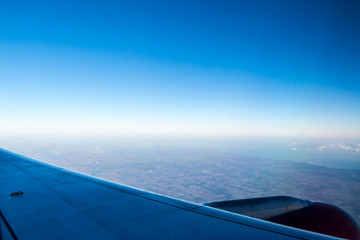 Beautiful view of a city and the sky from a plane window.