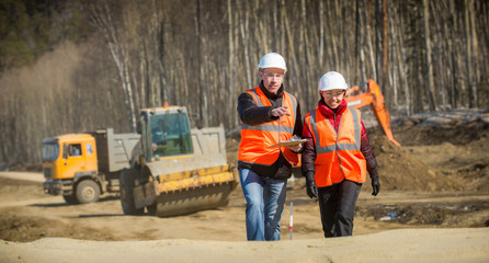 Road workers inspecting construction