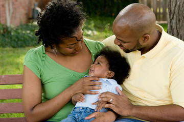 Wall Mural - Happy African American family with their baby.