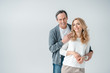 © LIGHTFIELD STUDIOS - portrait of smiling stylish mature man and woman on grey