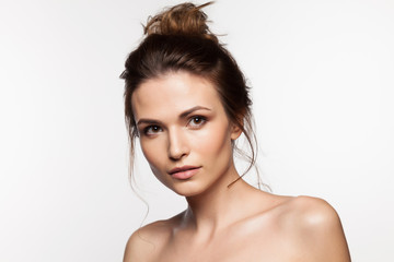 Brunette with bare shoulders on a white background