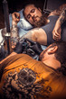 © Stop war in Ukraine! - Tattooer showing process of making a tattoo in tattoo studio