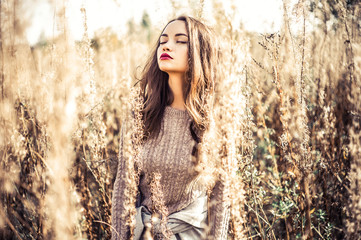 Fashion beautiful lady in autumn landscape