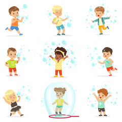 Wall Mural - Cute little girls and boys blowing and playing soap bubbles