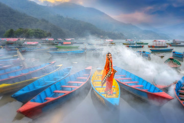 Women in sari standing on the boat,Phewa lake,Pokhara city , Nepal