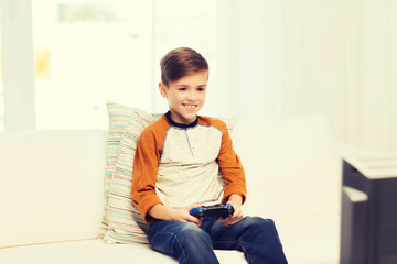 Wall Mural - happy boy with joystick playing video game at home