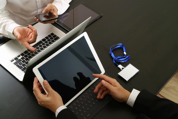 co working team meeting concept,businessman using smart phone and digital tablet and laptop computer and name tag in modern office