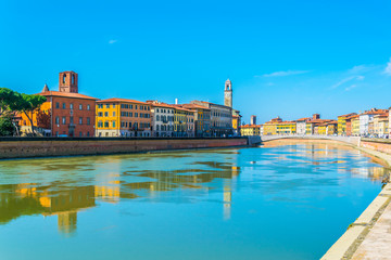 Wall Mural - Historical buildings stretched alongside river Arno in the historical center of the italian city Pisa.