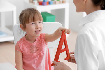 Wall Mural - Cute little girl at speech therapist office