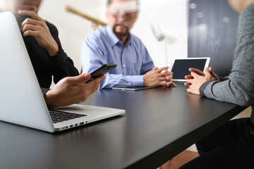 co working team meeting concept,businessman using smart phone and digital tablet and laptop computer in modern office