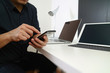 © everythingpossible - businessman working with smart phone and digital tablet and laptop computer in modern office