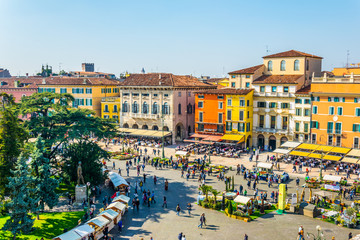 Wall Mural - People are strolling among flower stands during Saturday market on the piazza bra in the Italian city Verona