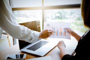 Asian Male accountant or banker making calculations. Savings, finance and economy concept.Coworking team.Closeup photo Young business managers working with new startup project in office.