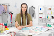 © Daco - fashion designer sitting at desk