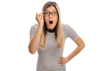 Wall Mural - Baffled young woman with eyeglasses looking at the camera