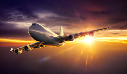 Wall Mural - airplane flying during sunset