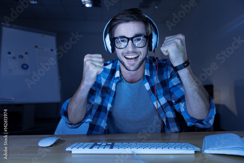 Cheerful delighted man winning the computer game Canvas Print