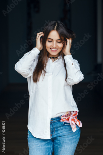 Portrait Of Smiling Laughing White Caucasian Brunette Young Beautiful Girl Woman Model With Long Dark Hair And Brown Eyes In White Shirt And Blue Jeans Looking Down Stock Photo Adobe Stock Portrait Of Smiling Laughing White Caucasian Brunette Young Beautiful Girl Woman Model With Long Dark Hair And Brown Eyes In White Shirt And Blue Jeans Looking Down Stock Photo Adobe Stock