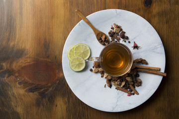 Food background with different black and green dry tea, rose buds cup of hot tea