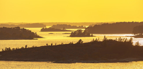 Wall Mural - Arial panoramic view of the archipelago of Stockholm during sunset in yellow silhouette