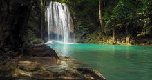 Beautiful Waterfall In Jungle Forest. Clean Emerald Water Flow Of Mountain River