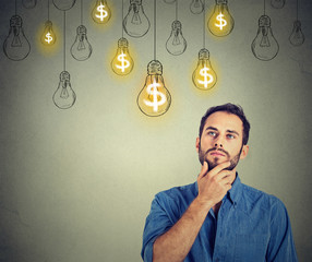 man looking up with dollar idea light bulb above head