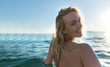 © Myvisuals - Portrait of a happy blonde woman enjoying her holiday on  the beach.
