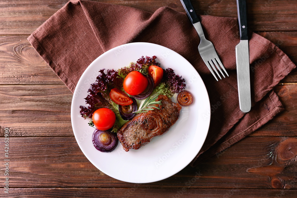 Delicious grilled steak with vegetables on plate