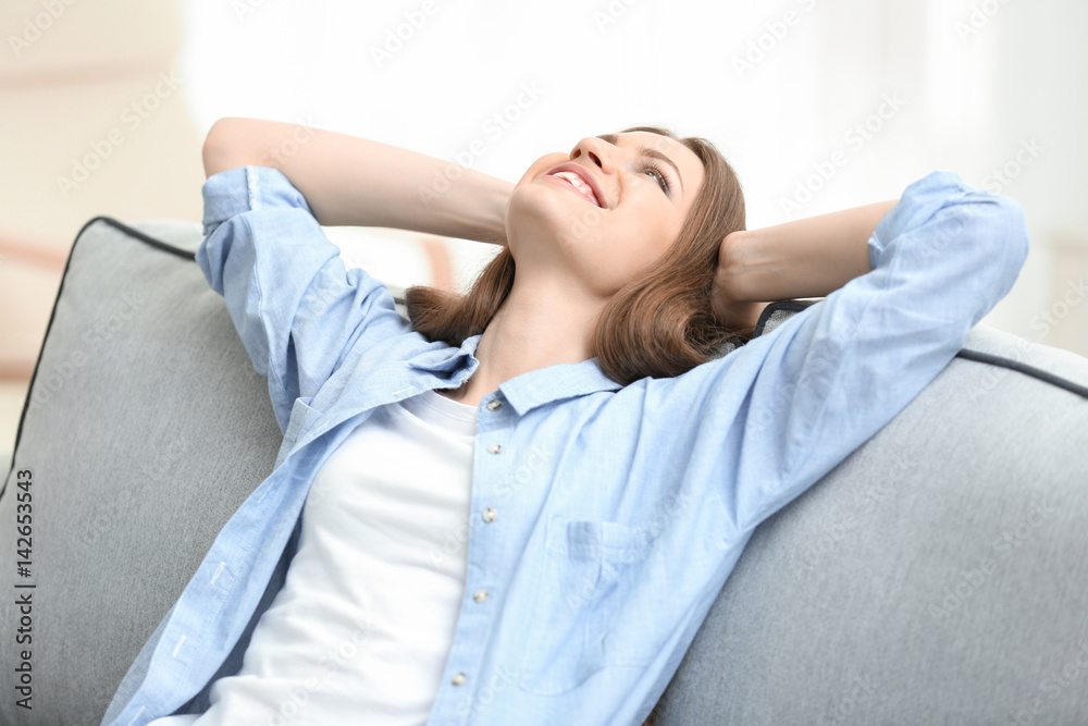 Beautiful young woman resting at home