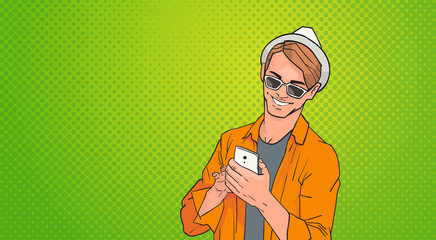 Poster - young man using cell smart phone networking online over pop art colorful retro style background vect