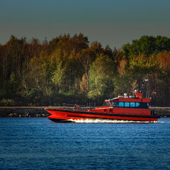 Sticker - Red pilot ship moving past the autumn trees in Europe