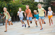 © JackF - kids actively playing and running together on street on summer day