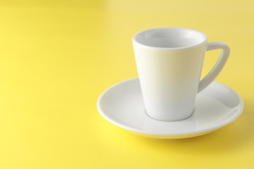 White cup isolated on yellow