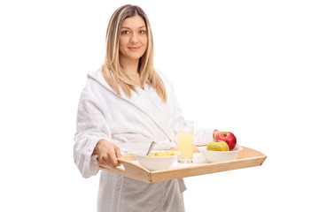 Poster - Young woman in a bathrobe holding a breakfast tray