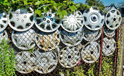 Fence From Decorative Car Wheel Covers Buy This Stock Photo And