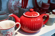 Red porcelain teapot in sideboard