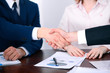© rogerphoto - Business people shaking hands finishing up a meeting