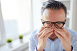 © Syda Productions - businessman in glasses rubbing eyes at office