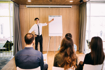 web designers standing at office planning website layout on flipchart