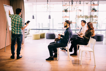 Tech start-up business team discussing product roadmap for product and investment in office