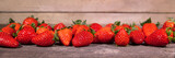 Banner, viele rote Erdbeeren auf Holz