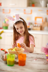 Wall Mural - Girl painting orange egg with watercolor