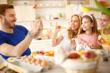 Wall Mural - Family photo on cell phone for Easter