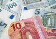 © Anton - Euro banknotes and coins lie on top of each other