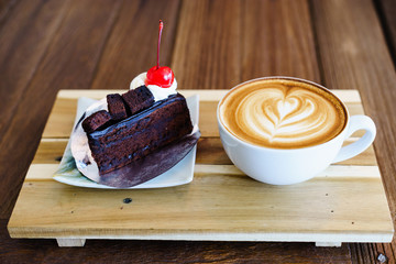 Wall Mural - late coffee with chocolate cake on wood table.