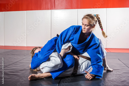 Zdjęcie XXL Młoda kobieta w kimono sprawia bolesne przyjęcie: Judo, jujitsu, Tatami, siłownia