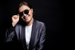 © chajamp - Happy businesswoman wearing sun glasses on isolated background